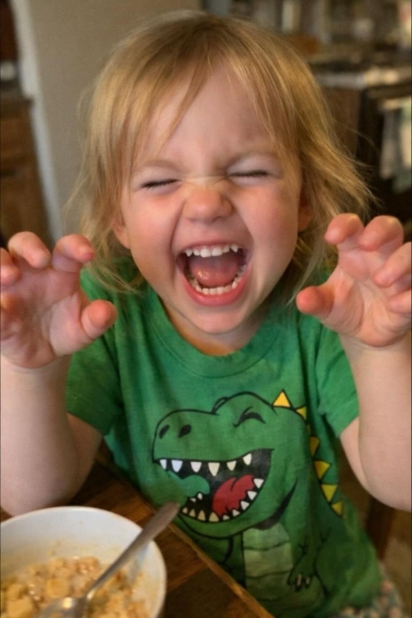 A four-year-old roaring like a lion at the camera